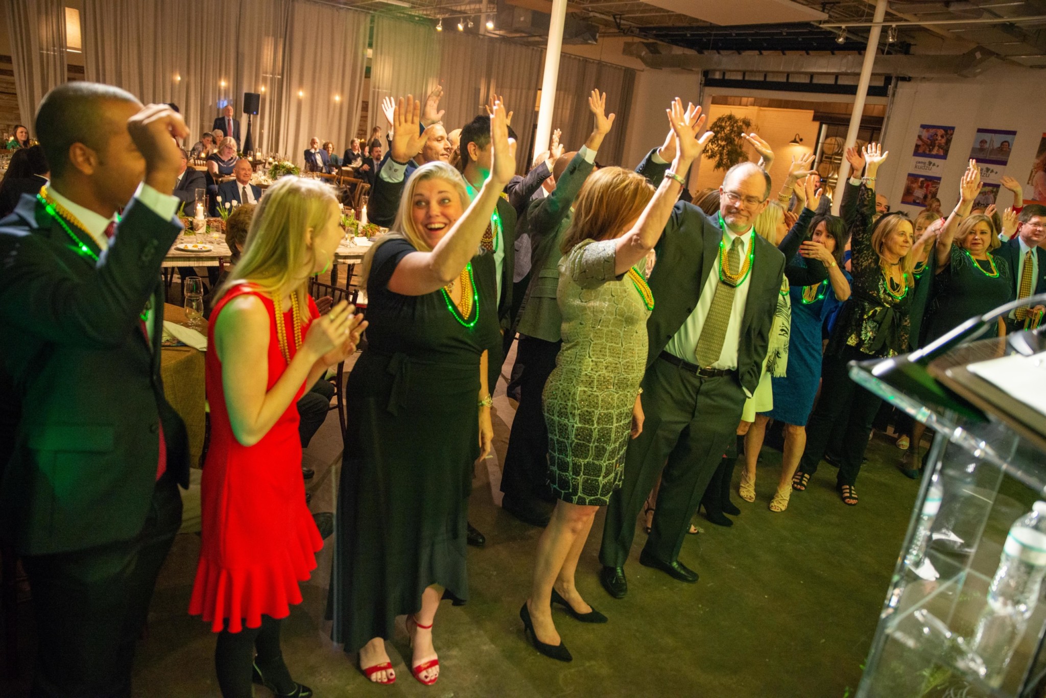 Event attendees raising their hands at a Camp Kudzu event