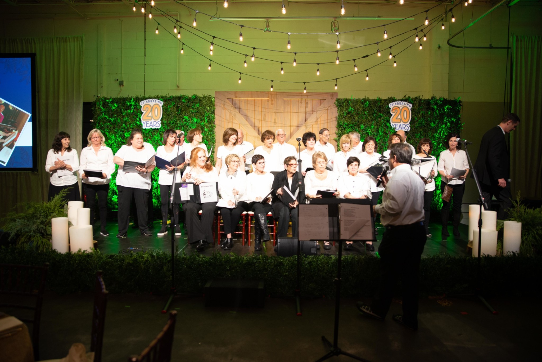 Choir on stage signing at a Camp Kudzu event