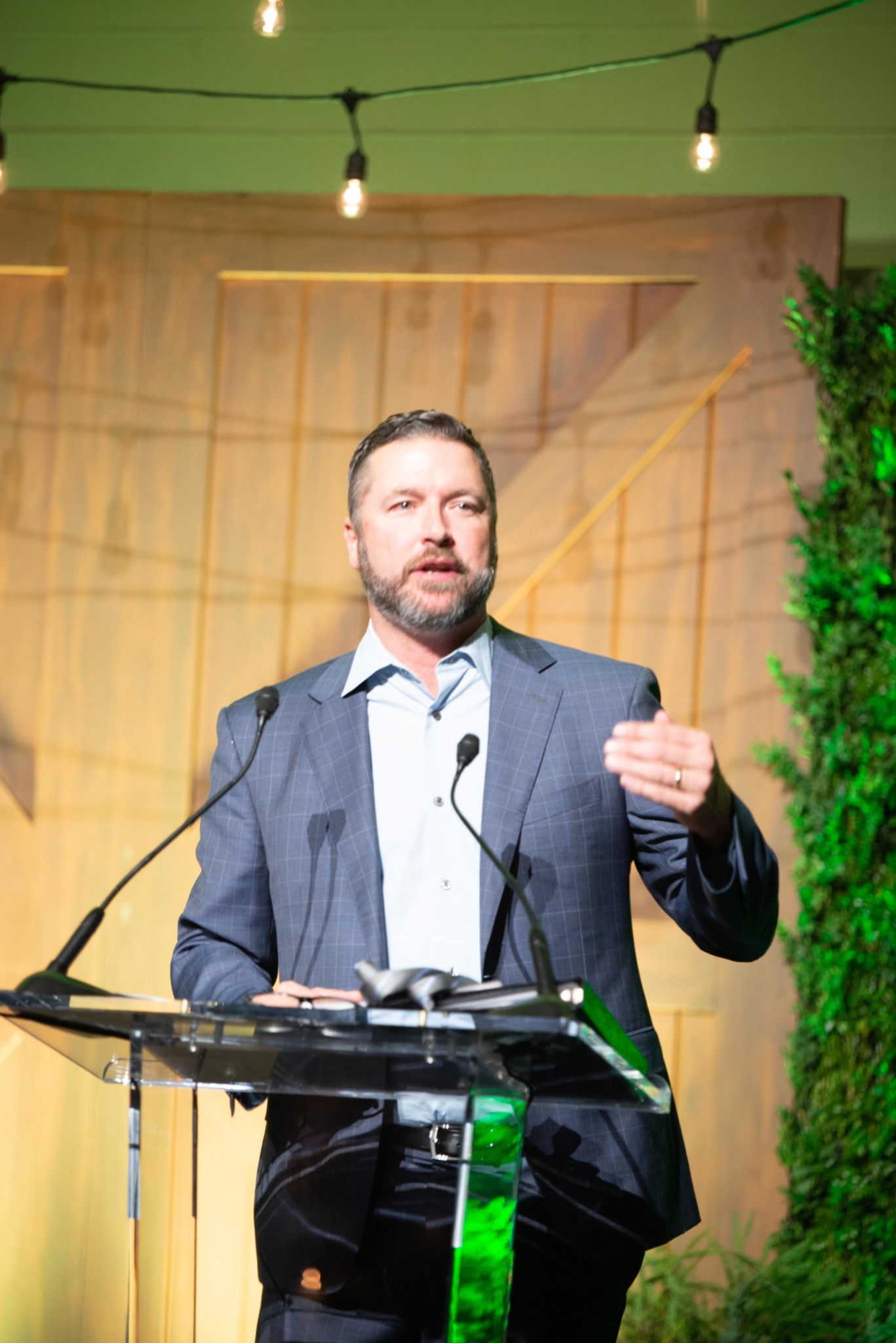 Man in front of a podium at a Camp Kudzu event