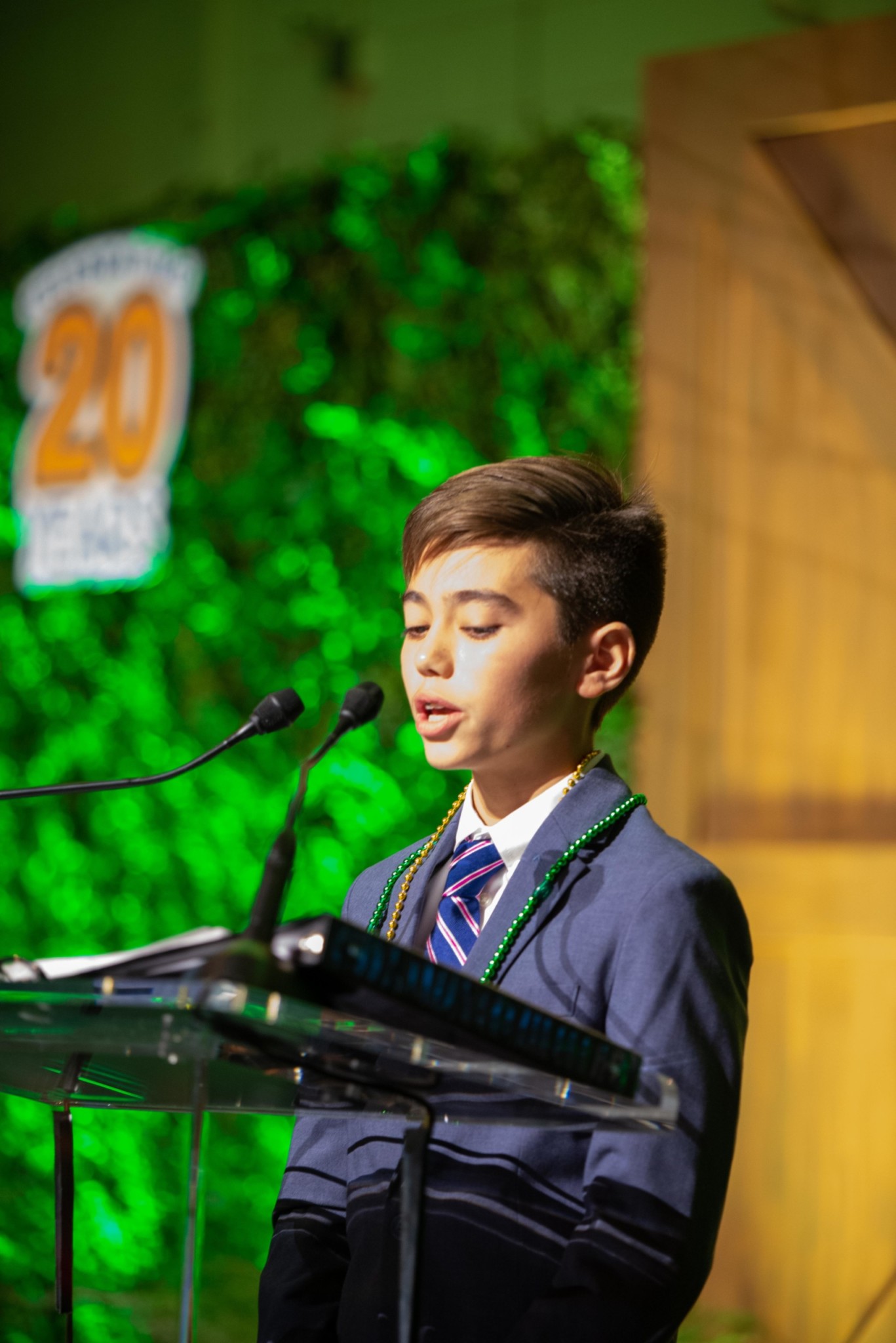 Child in front of a podium at a Camp Kudzu event