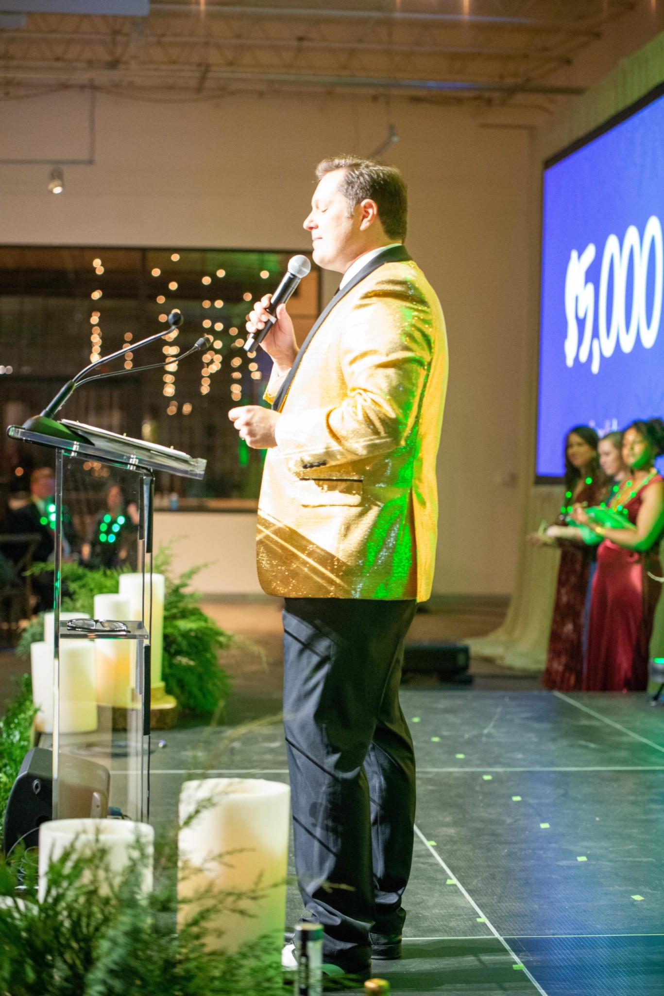 Man hosting an auction at a Camp Kudzu event