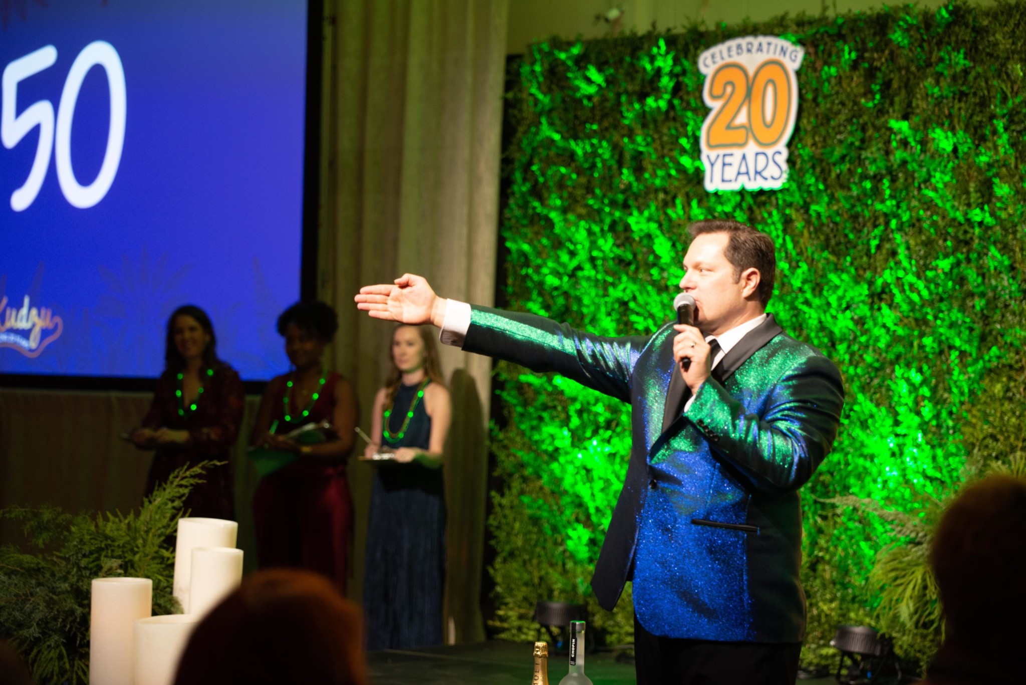 Man hosting an auction at a Camp Kudzu event